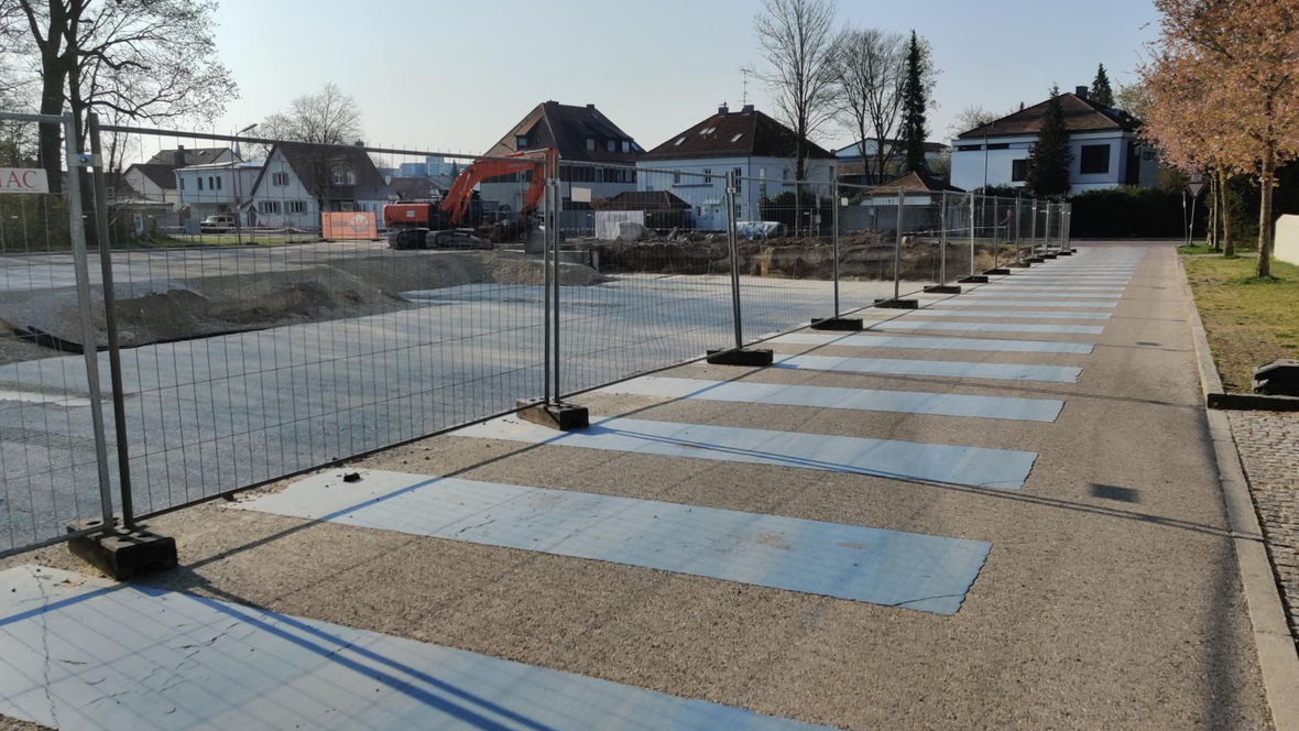 Bauzaun und Bagger auf der Baustelle am Parkbad in Neuburg